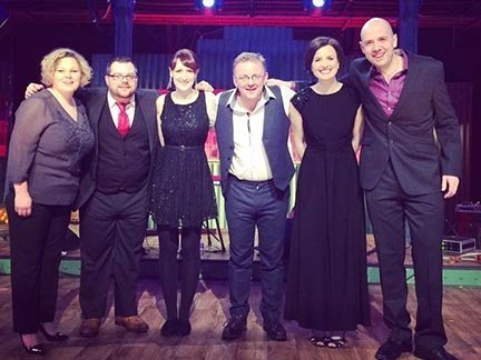 Members of Blazin’ Fiddles posing together at a music awards event