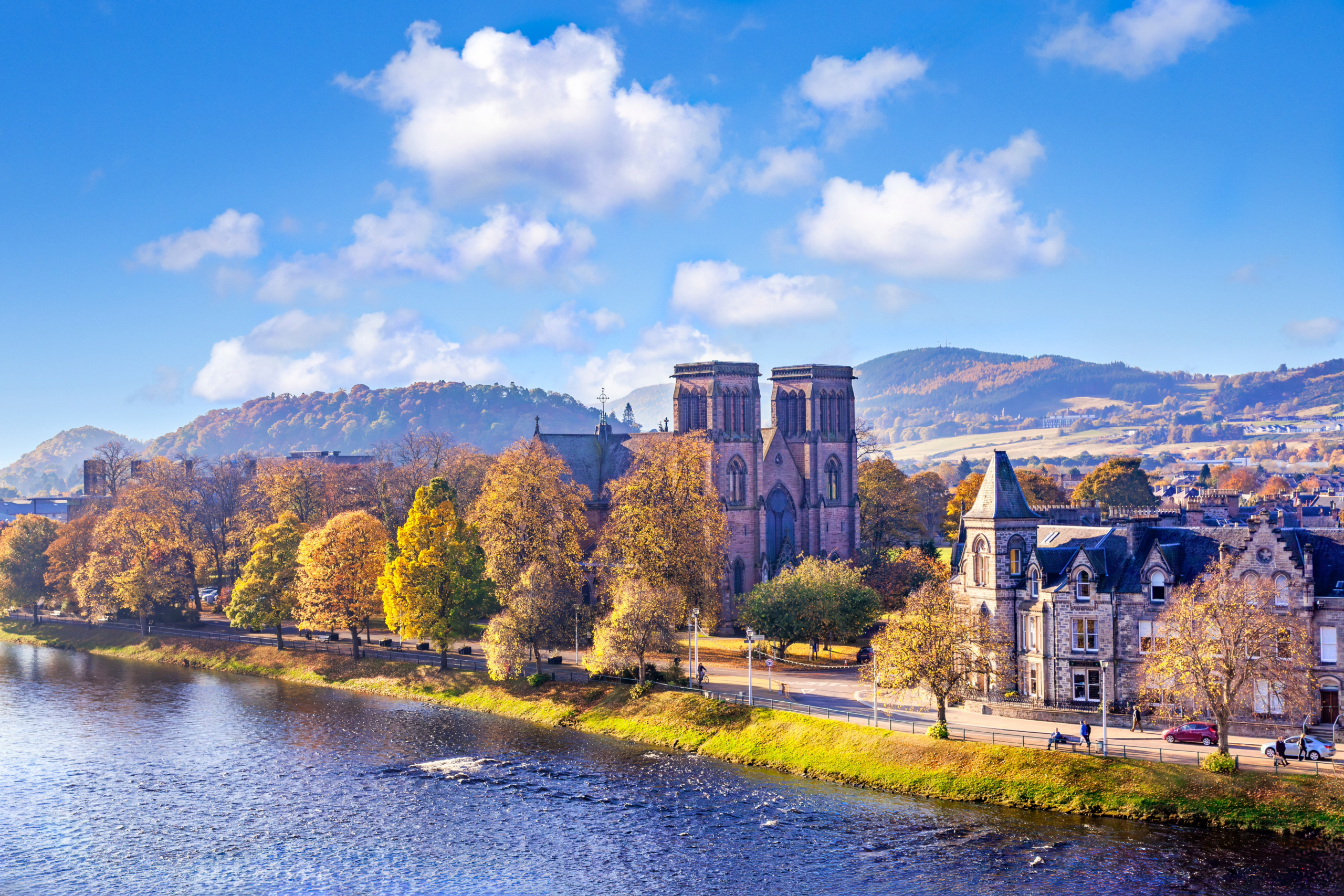 Inverness Cathedral beside the River Ness with autumn trees and hills beyond